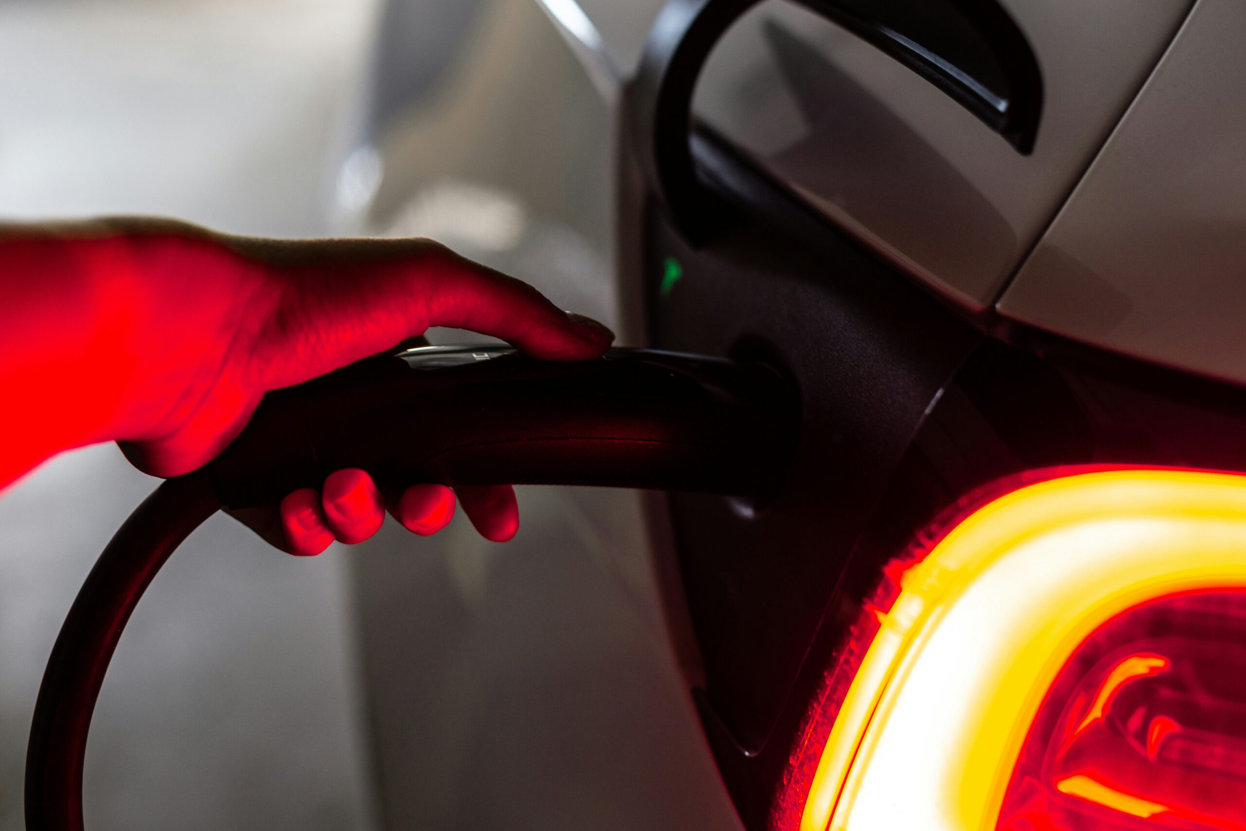 Close up of an electric vehicle being charged.