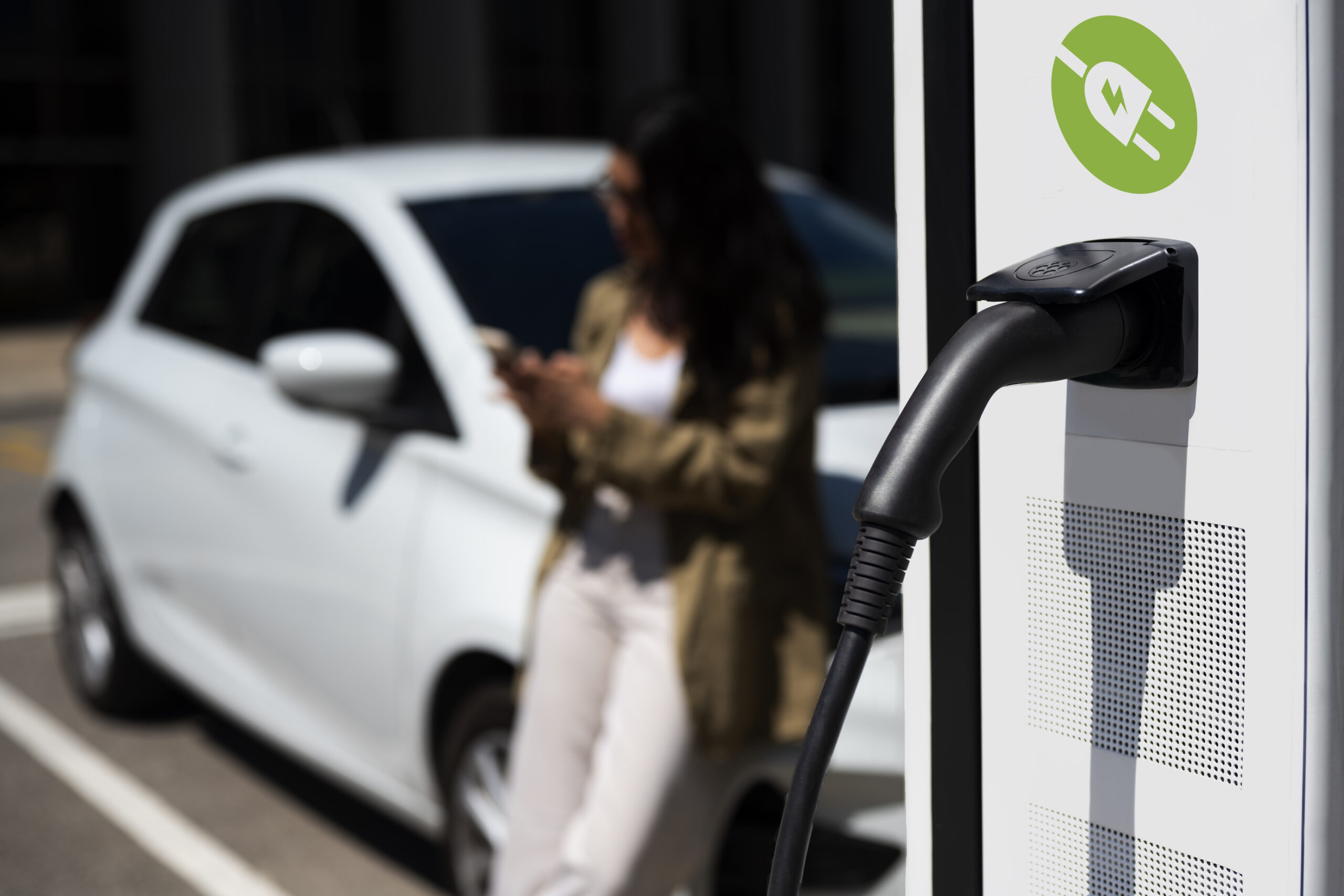 A person waits for their electric vehicle to charge.