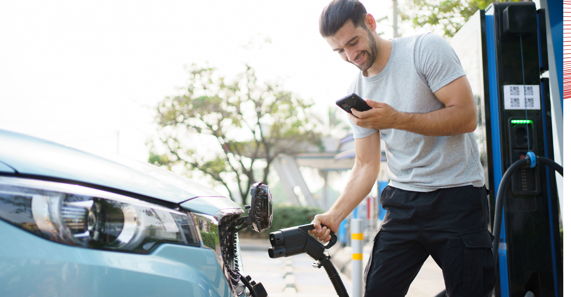 A man plugging in his electric car to charge.