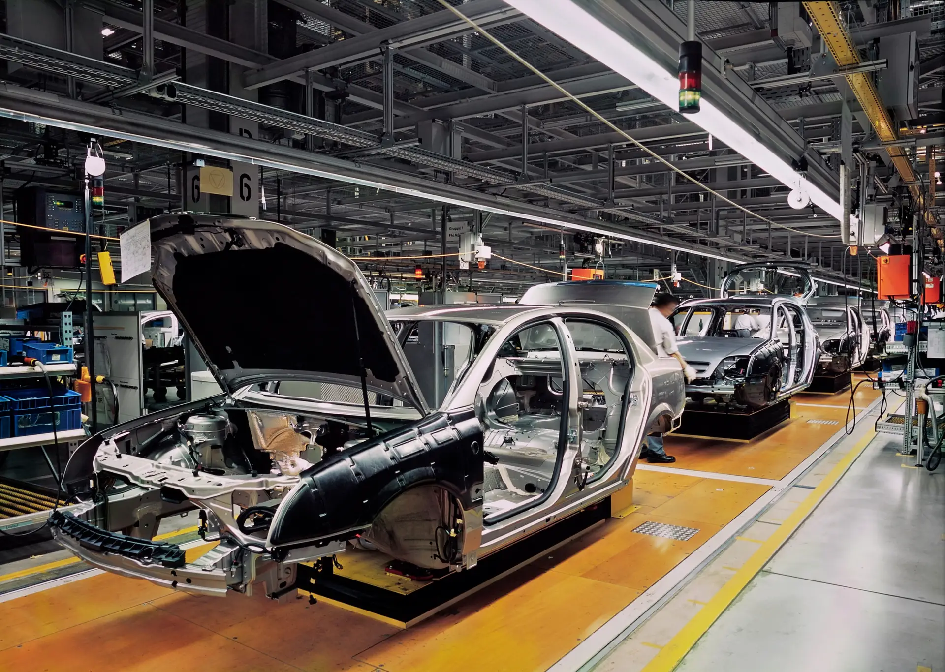 Car production line with unfinished cars in a row.